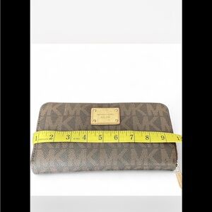 Michael Kors Gold Logo Plate on Brown Texture